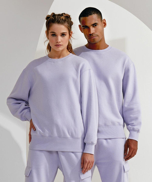 Two individuals stand side by side, both wearing matching light purple TR603 sweatshirts and pants from TriDri, with a plain background behind them.
