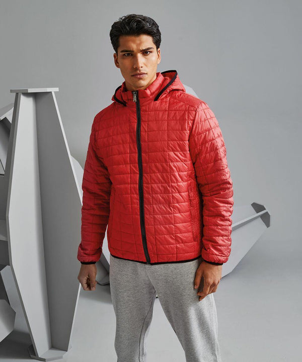 Man wearing a red 2786 TS023 quilted jacket with a hood and gray sweatpants, standing against a gray background with abstract geometric shapes.