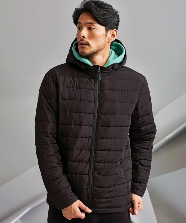 A man wearing a black 2786 TS043 with a hood and a green hooded sweatshirt underneath stands indoors against a grey background.