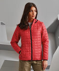 A person wearing a red 2786 TS23F puffer jacket stands indoors, posing with one hand in their pocket and looking to the side.