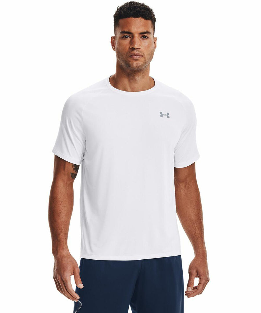A man wearing a white short-sleeve Under Armour UA005 t-shirt and navy blue pants, standing and facing forward.