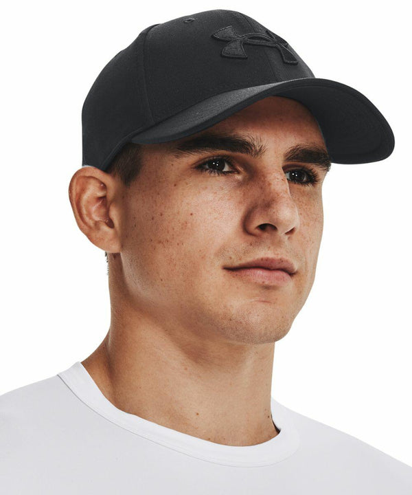 A person wearing a black Under Armour UA046 with a logo looks slightly off to the side. They are also wearing a white shirt.