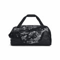 Under Armour's UA052 duffel bag features a black and gray camo design, complete with black handles and a shoulder strap.