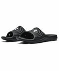 A pair of black open-toe slides with a contoured footbed and the Under Armour logo on the strap, called UA054 by Under Armour.
