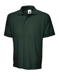A Uneek UC102 adult unisex heavyweight polo shirt in Bottle Green