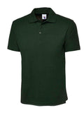 A Uneek UC105 adult unisex active polo shirt in Bottle Green