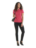 A woman wearing a UC115 Hot Pink  Uneek ladies ultra cotton polo shirt with Black trousers