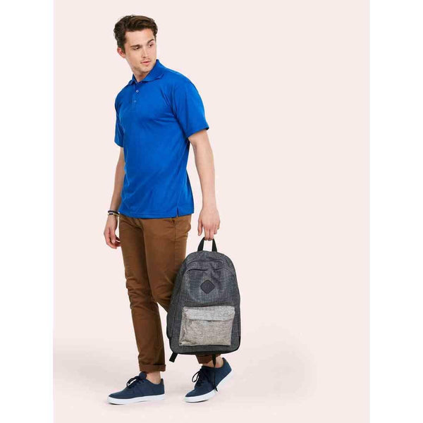 A man wearing a UC121 Royal Uneek Processable polo shirt with Tan trousers