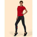 A woman wearing a UC316 Red Uneek ladies ultra cool t-shirt with Black leggings