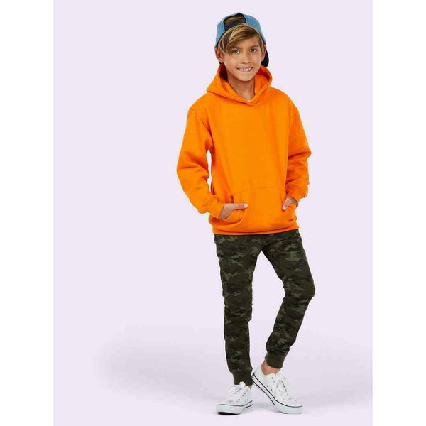 A boy wearing a UC503 Orange Uneek childrens hooded sweatshirt with Camoflauge joggers