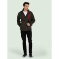 A man wearing a UC601 Charcoal Uneek adults heavyweight full zip fleece with Black jeans