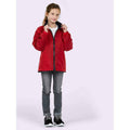 A girl wearing a UC606 Red Uneek childrens reversible fleece with Grey jeans