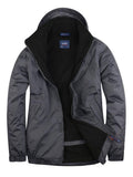 A Uneek Premium Outdoor Jacket in Deep Grey & Black on a white background
