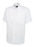 UC702 White button-up short-sleeved shirt by Uneek displayed on a white background, featuring a pointed collar and a left chest pocket.