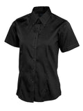 A black short-sleeved Uneek UC704 button-up shirt displayed on a white background.