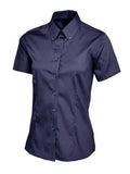 A navy short-sleeved Uneek UC704 button-up shirt displayed on a white background.
