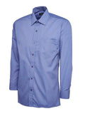 A mid blue, long-sleeved UC709 dress shirt with a button-up front and a single chest pocket, displayed on a plain background by Uneek.