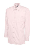 A pink, long-sleeved UC709 dress shirt with a button-up front and a single chest pocket, displayed on a plain background by Uneek.