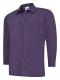 A purple, long-sleeved UC709 dress shirt with a button-up front and a single chest pocket, displayed on a plain background by Uneek.