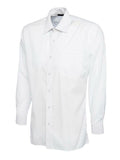 A white, long-sleeved UC709 dress shirt with a button-up front and a single chest pocket, displayed on a plain background by Uneek.