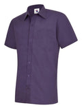 A purple, short-sleeved UC710 dress shirt with a button-up front and a single chest pocket, displayed on a plain background by Uneek.