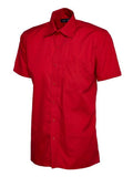 A red, short-sleeved UC710 dress shirt with a button-up front and a single chest pocket, displayed on a plain background by Uneek.