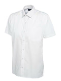 A white, short-sleeved UC710 dress shirt with a button-up front and a single chest pocket, displayed on a plain background by Uneek.