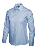 A light blue UC711 button-down dress shirt displayed on a white background, featuring a pointed collar and long sleeves.