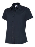A navy, button-up shirt with short sleeves and a pointed collar from Uneek (UC712), displayed on a plain white background.