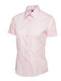 A pink, button-up shirt with short sleeves and a pointed collar from Uneek (UC712), displayed on a plain white background.