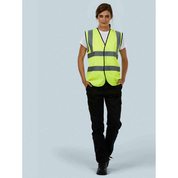 A woman wearing a UC801 Yellow Uneek hi-viz safety waistcoat with Black trousers