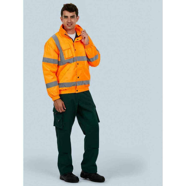 A man wearing a UC804 Orange Uneek hi-viz bomber jacket with Bottle trousers