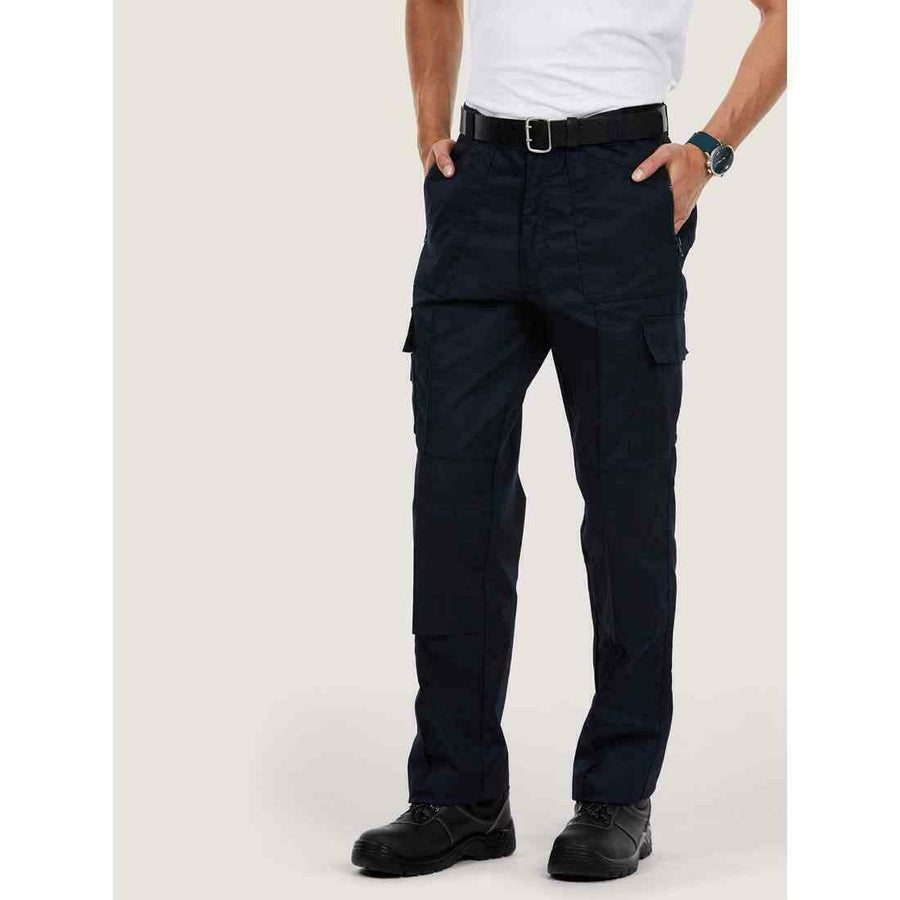 A man wearing a UC903 Navy Uneek action trousers