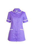 A Uneek short-sleeve ladies scrub tunic in purple with white trim on collar, sleeves, and pockets, displayed on a white background.
