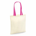 A tote bag from Westford Mill, model W101C, featuring a cream color with vibrant pink handles, positioned upright against a simple white backdrop.