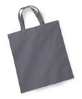 A plain tote bag in dark gray, featuring two handles and laid flat on a white background, is described by the product name W101S from Westford Mill. Its simple and unadorned design highlights the smooth fabric surface.