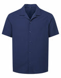 The Wombat WB500, a plain navy blue short-sleeve button-up shirt, is showcased against a white background.