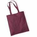 A maroon fabric tote bag, labeled as the WM101 from Westford Mill, with two shoulder straps, is lying flat against a white background.