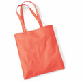 The WM101 by Westford Mill is a vibrant orange tote bag with two handles resting on a white background. The bag is made of fabric, unadorned, and appears to be both reusable and eco-friendly.
