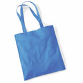 A Westford Mill WM101 tote bag in plain blue, featuring two long handles, is laid flat against a white background.