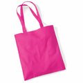 A bright pink cotton tote bag, Product Name: WM101, from Westford Mill, with two handles lying flat against a white background.