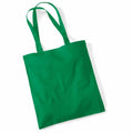 A Westford Mill WM101 tote bag in vibrant green, featuring two long handles, is displayed against a plain white background. The fabric bag appears empty, highlighting its flat, rectangular shape.