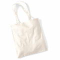A WM101 tote bag from Westford Mill, featuring a plain white canvas design and two handles, is lying flat against a white background. The bag looks simple and unadorned, ideal for carrying groceries or personal items.