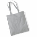 A WM101 tote bag from Westford Mill, featuring a plain gray design with two handles, is resting on a white background. The fabric bag has a slightly wrinkled appearance.