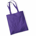 A plain purple Westford Mill WM101 tote bag with two handles, displayed on a white background.