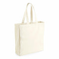 The Westford Mill WM108 is a plain, beige canvas tote bag with two handles, standing upright against a white background.