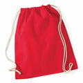 The WM110 backpack by Westford Mill, featuring a red design with beige drawstrings, is displayed against a white background.