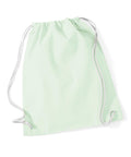 A light green WM110 drawstring bag from Westford Mill, featuring white cords, is laid flat against a plain white background. The bag boasts a simple and minimalistic design.