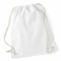 A plain white drawstring bag, WM110 by Westford Mill, with beige cords lying on a white surface. The bag features a simple design and the cords thread through the top, allowing it to be pulled closed.