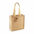 A tote bag from the Westford Mill collection, featuring a beige jute design with two handles and an attached tag. The product name is WM406.